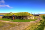 Replica Viking longhouse and longboat near Haroldswick.