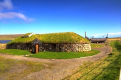 Replica Viking longhouse and longboat near Haroldswick.
